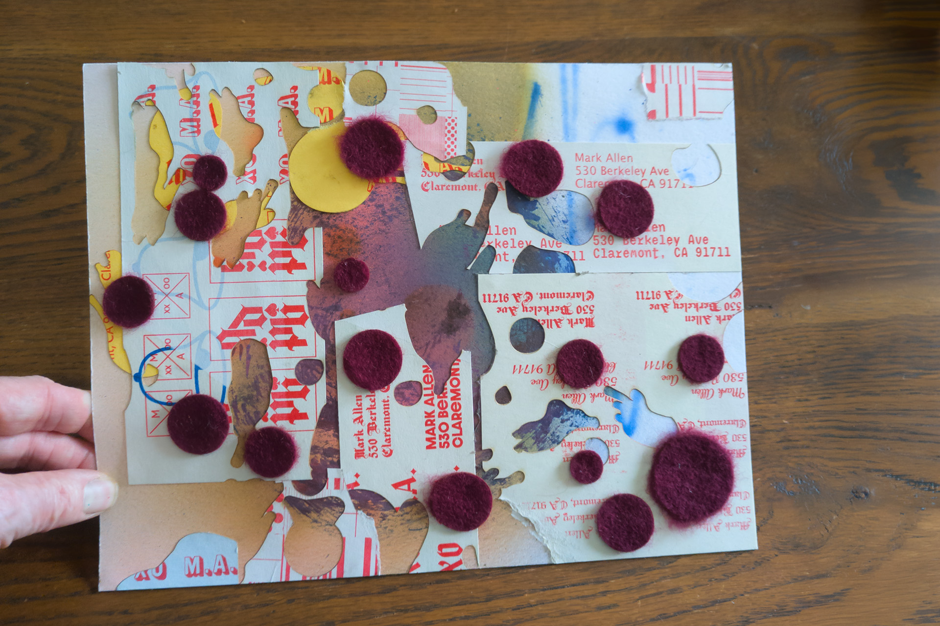 mail art with cut-out shapes and large purple circles
